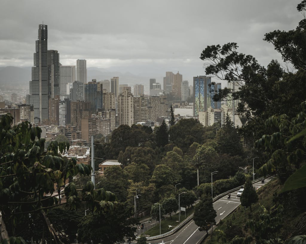 Explore the urban skyline of Bogotá from a scenic viewpoint, blending city life with lush greenery.