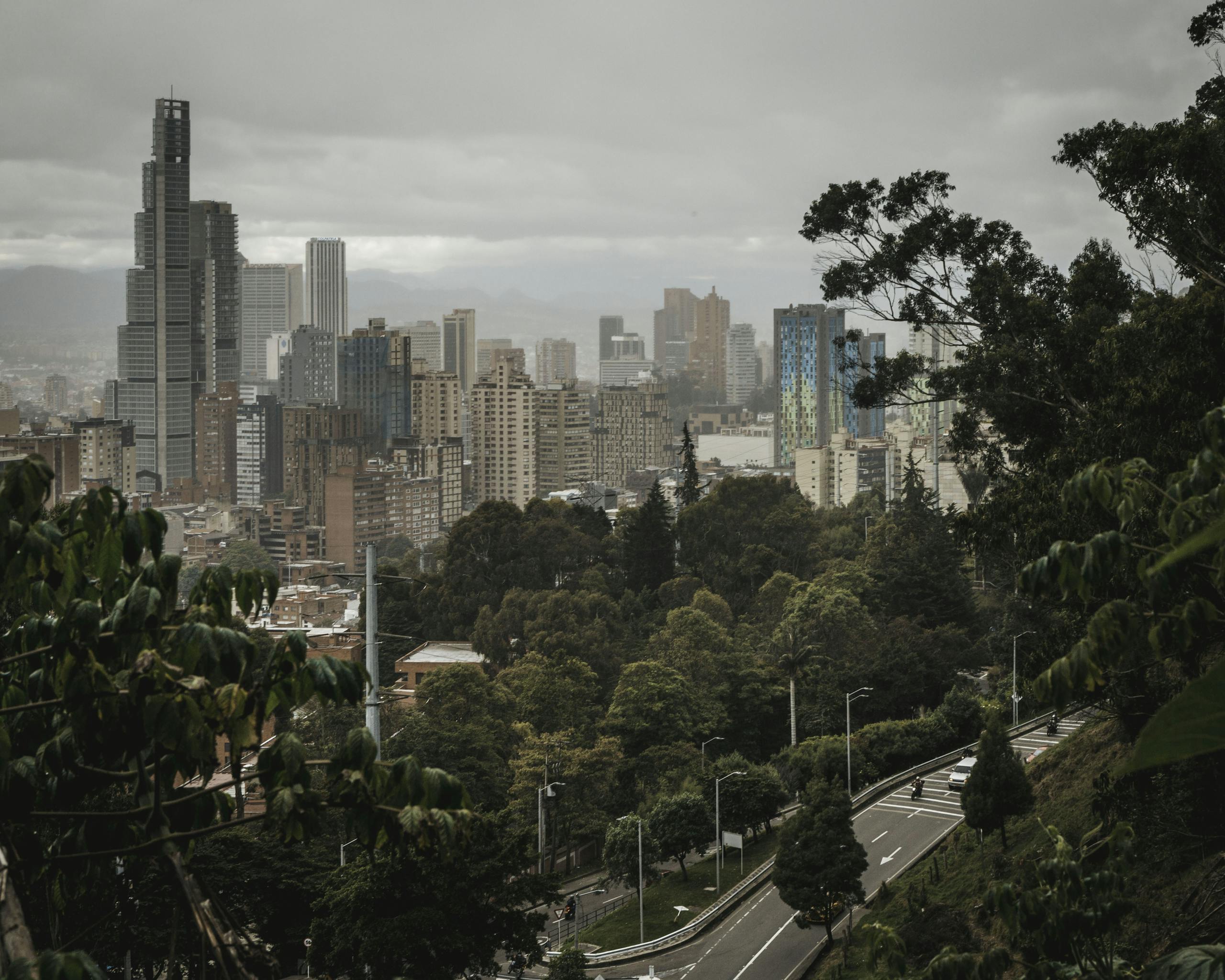 Explore the urban skyline of Bogotá from a scenic viewpoint, blending city life with lush greenery.